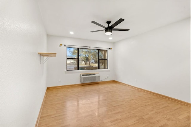 unfurnished room featuring baseboards, a ceiling fan, wood finished floors, a wall mounted air conditioner, and recessed lighting