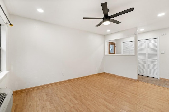 unfurnished bedroom with recessed lighting, ceiling fan, baseboards, and wood finished floors