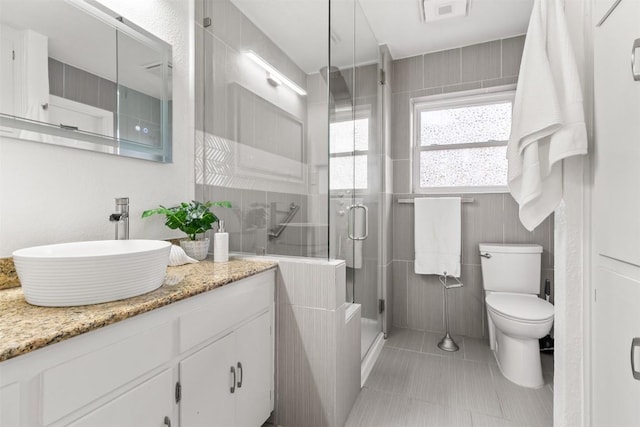 full bath with visible vents, toilet, tile patterned flooring, vanity, and a shower stall