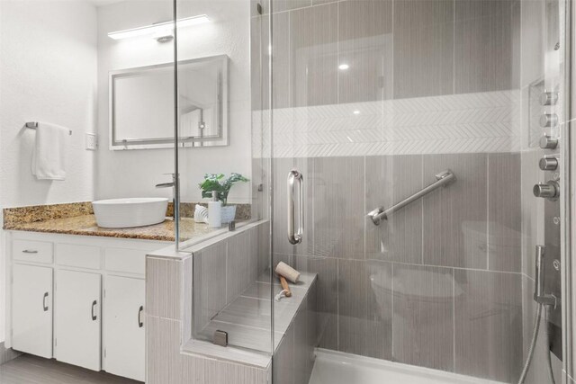 full bath featuring a shower stall and vanity