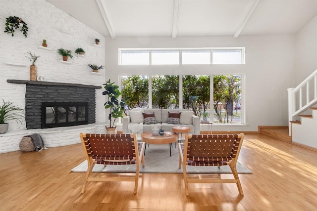 living area featuring plenty of natural light, a fireplace, and wood finished floors