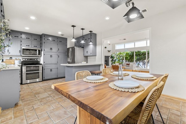 dining room featuring recessed lighting, stone tile flooring, and visible vents