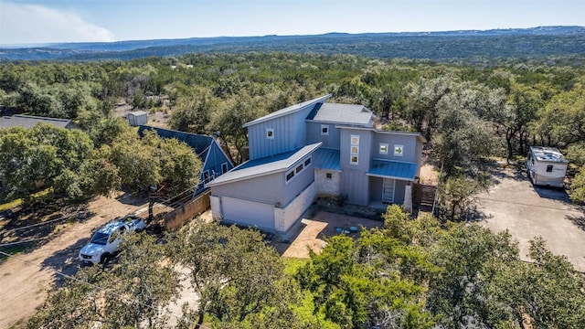 birds eye view of property featuring a view of trees