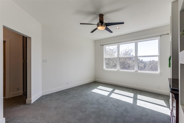 interior space with a ceiling fan, baseboards, and carpet flooring