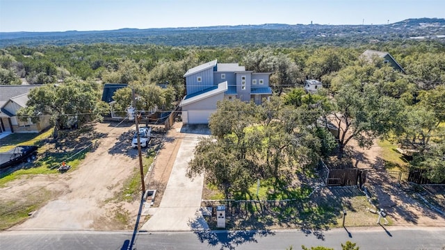 bird's eye view with a wooded view