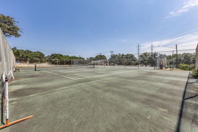 view of sport court featuring fence