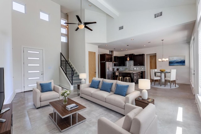 14805 Foy Dr, Austin, TX 78734 - living area featuring high vaulted ceiling, stairs, a ceiling fan, a chandelier, and concrete floors