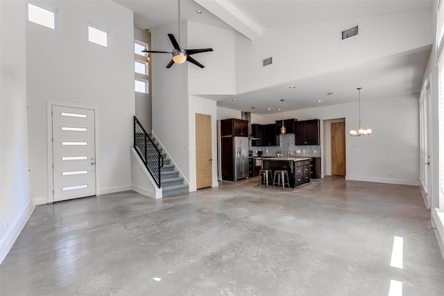 14805 Foy Dr, Austin, TX 78734 - unfurnished living room featuring finished concrete floors, a ceiling fan, high vaulted ceiling, a chandelier, and stairway