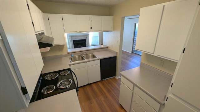 kitchen with black dishwasher, dark wood-type flooring, light countertops, a sink, and exhaust hood