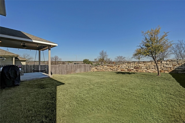 view of yard featuring ceiling fan, a patio, and fence