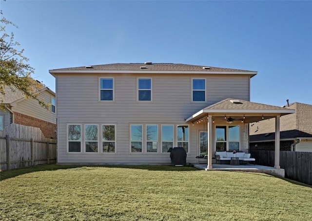 back of property with a patio area, a fenced backyard, a yard, and an outdoor hangout area