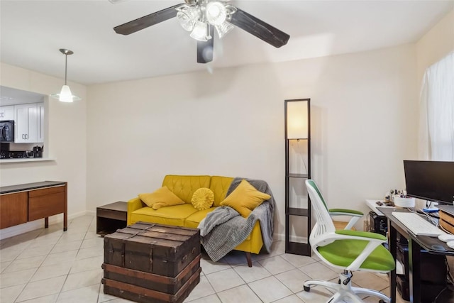 living room featuring a ceiling fan, light tile patterned flooring, and baseboards