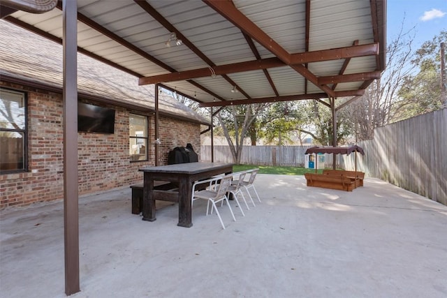 view of patio / terrace with outdoor dining area, grilling area, and a fenced backyard