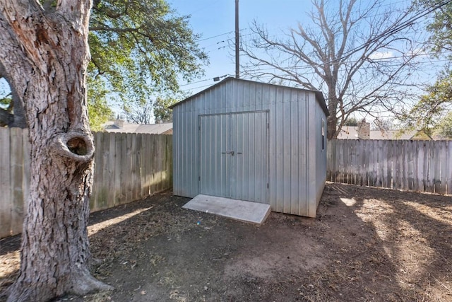 view of shed with a fenced backyard