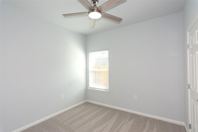 unfurnished room with baseboards, a ceiling fan, and light colored carpet