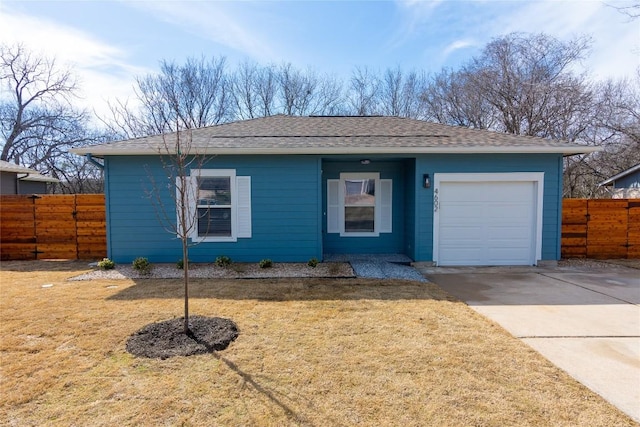 ranch-style home featuring a garage, driveway, fence, and a front yard