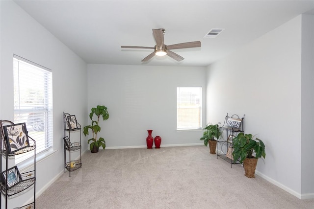 misc room featuring carpet floors, plenty of natural light, and baseboards