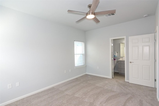 unfurnished bedroom with visible vents, light carpet, connected bathroom, ceiling fan, and baseboards