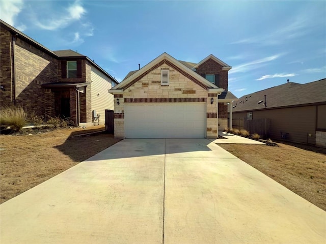 view of front of home with driveway, stone siding, an attached garage, and brick siding