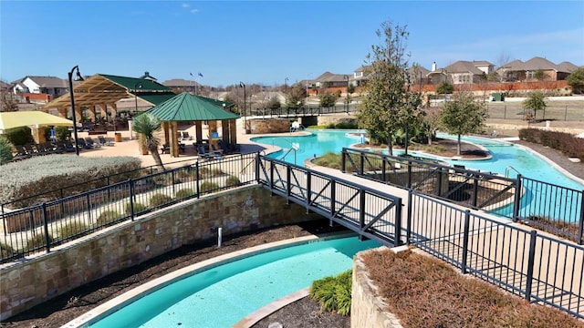 171 Longstraw Dr, Buda, TX 78610 - community pool with a gazebo, a residential view, and a patio area