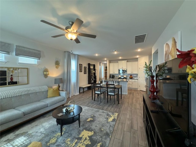 171 Longstraw Dr, Buda, TX 78610 - living room featuring wood finished floors, ceiling fan, and recessed lighting