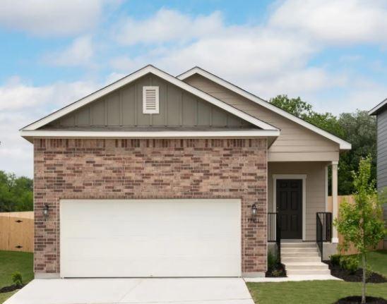 view of front of home featuring brick siding, an attached garage, board and batten siding, a front yard, and driveway