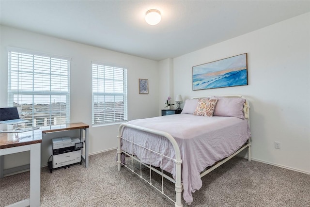 carpeted bedroom featuring baseboards