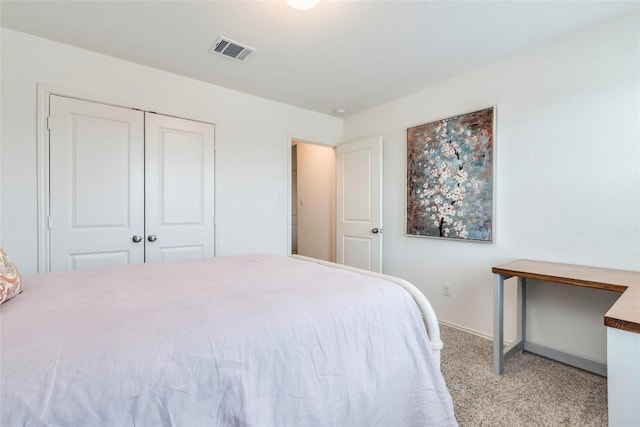 bedroom with carpet floors, baseboards, visible vents, and a closet