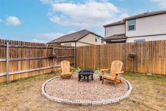 view of yard featuring a fire pit and a fenced backyard