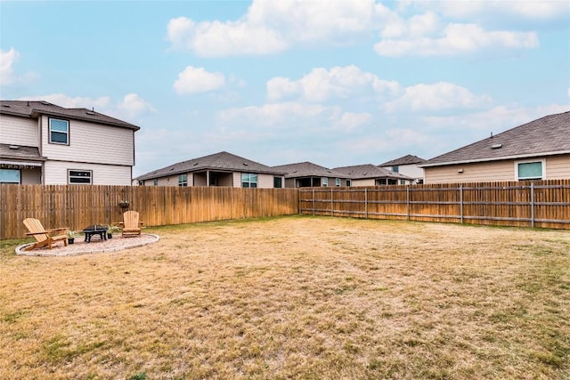 view of yard featuring an outdoor fire pit and a fenced backyard