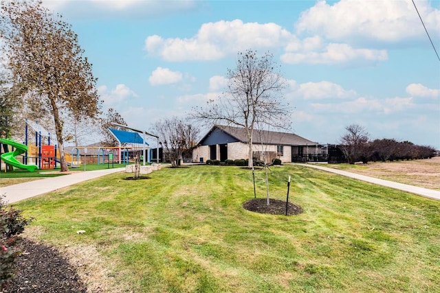 view of front facade featuring a front lawn and playground community