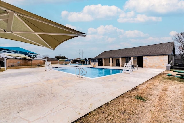 pool with fence and a patio