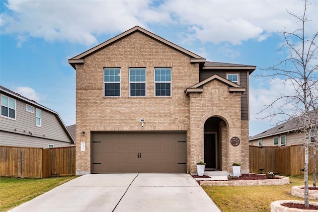 traditional home featuring concrete driveway, brick siding, fence, and a front lawn