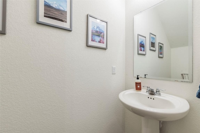 bathroom with a sink and a textured wall