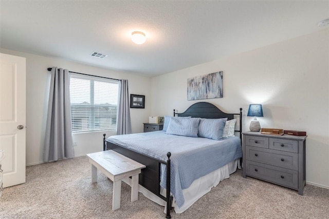 bedroom with light carpet and visible vents