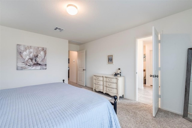 bedroom featuring visible vents and light colored carpet