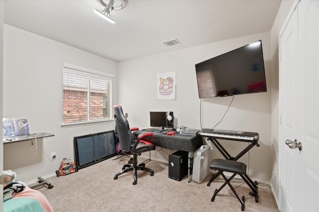 carpeted office with visible vents and baseboards