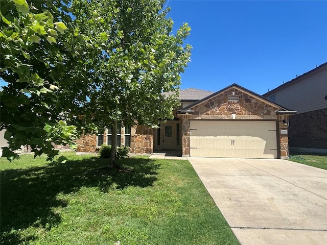 5105 Fenton Ln, Belton, TX 76513 - view of front facade with stone siding, an attached garage, a front lawn, and concrete driveway