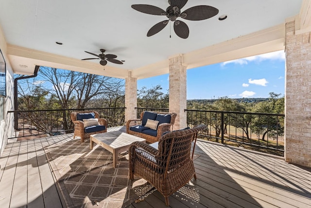 deck featuring ceiling fan and an outdoor living space