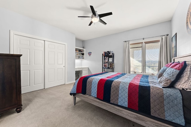 bedroom with a closet, a ceiling fan, and carpet flooring