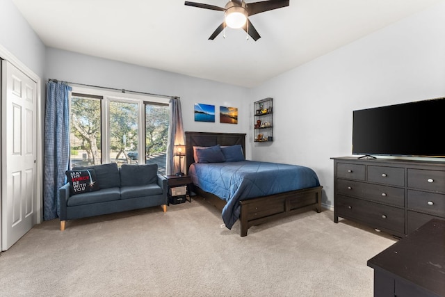 bedroom featuring a ceiling fan and light colored carpet