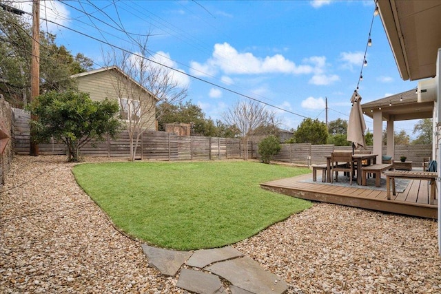 view of yard with a fenced backyard and a wooden deck