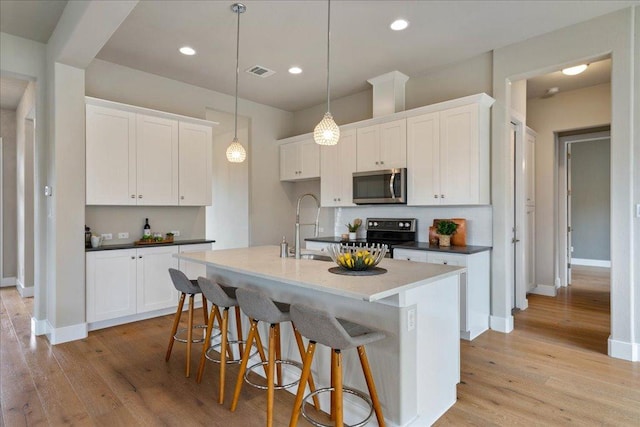 3011 Chisholm Trl, Austin, TX 78734 - kitchen featuring stainless steel appliances, light wood-style flooring, white cabinetry, decorative backsplash, and recessed lighting