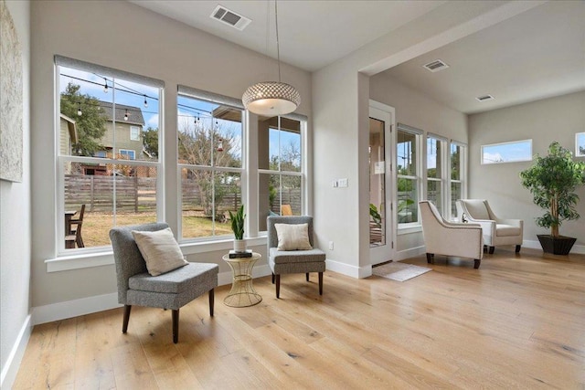 sunroom featuring plenty of natural light and visible vents