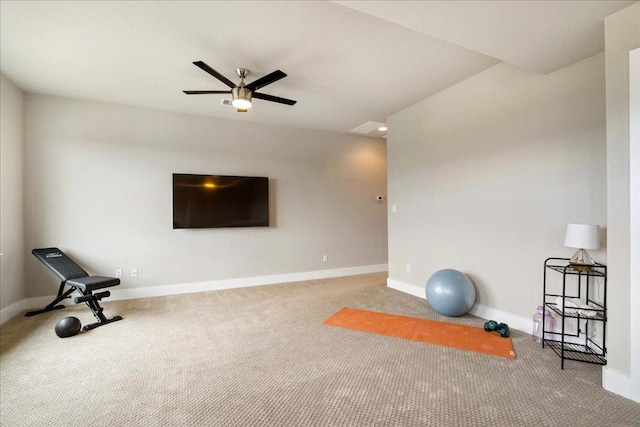 exercise room featuring carpet floors, baseboards, and a ceiling fan