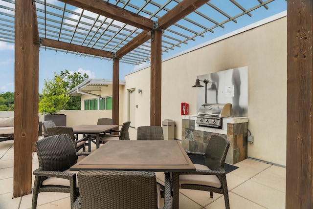 view of patio / terrace with exterior kitchen, area for grilling, outdoor dining space, and a pergola