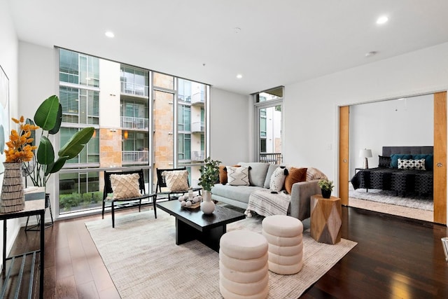 living room with recessed lighting, plenty of natural light, floor to ceiling windows, and wood finished floors