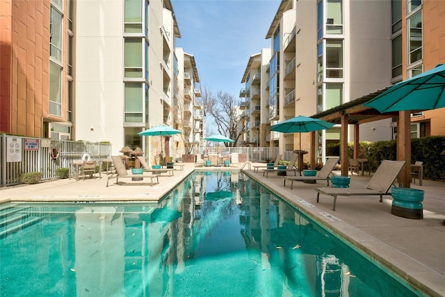 pool featuring a patio area and fence