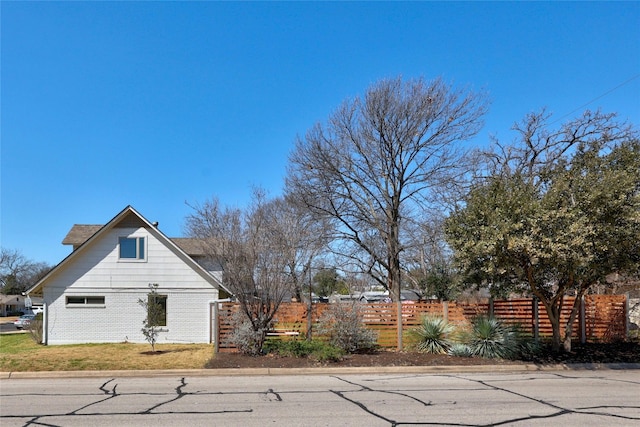 view of side of property featuring fence