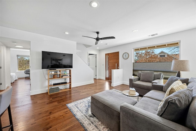 living area with baseboards, wood finished floors, visible vents, and recessed lighting